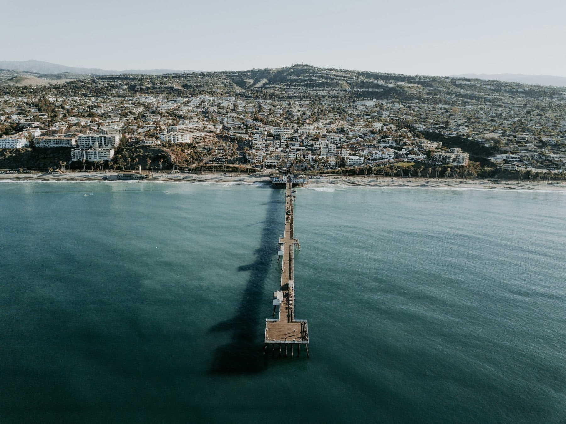 Aerial view of the San Clemente Pier and the town on the hills behind it, San Clemente, California